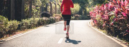 Photo for Fitness woman runner running on winter park trail - Royalty Free Image