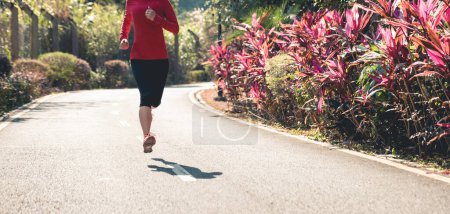 Photo for Fitness woman runner running on winter park trail - Royalty Free Image