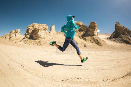 Photo for Fitness woman trail runner cross country running on sand desert - Royalty Free Image
