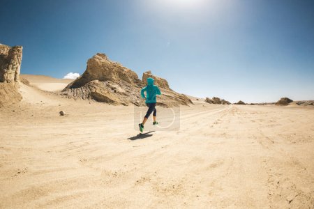 Photo for Fitness woman trail runner cross country running on sand desert - Royalty Free Image