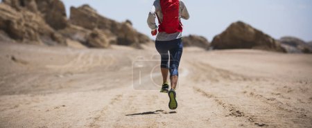 Photo for Fitness woman trail runner cross country running  on sand desert - Royalty Free Image