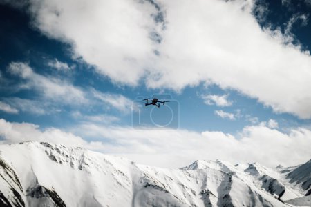 Photo for Flying drone taking photo of snow mountains - Royalty Free Image