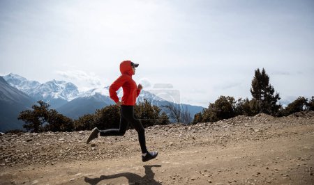 Photo for Woman trail runner cross country running at high altitude mountains - Royalty Free Image
