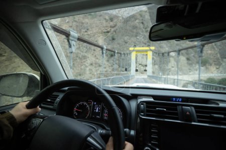 Photo for Driving car on high altitude drawbridge, China - Royalty Free Image