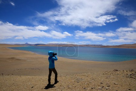 Photo for Woman hiker hiking in winter high altitude mountain, China - Royalty Free Image