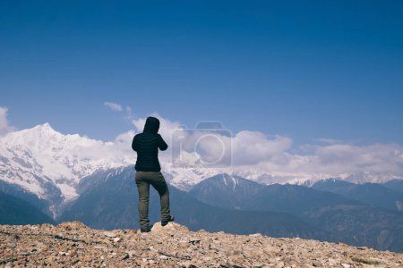 Photo for Woman photographer in winter high altitude glacier mountain,China - Royalty Free Image
