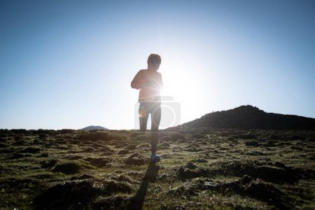 Photo for Woman trail runner cross country running at high altitude mountain peak - Royalty Free Image