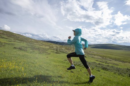 Téléchargez les photos : Femme trail runner cross country courir à haute altitude prairie - en image libre de droit