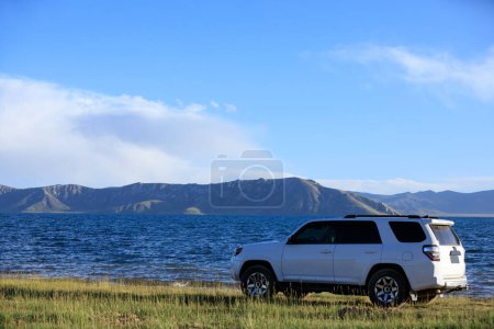 Photo for Driving White 2020 Toyota 4Runner TRD crossing in the sunset lakeside trip - Royalty Free Image