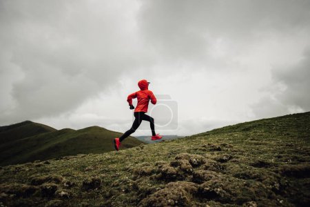 Photo for Woman runner running at mountain top - Royalty Free Image