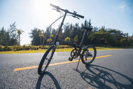 Photo for A folding bike on sunrise seaside road - Royalty Free Image