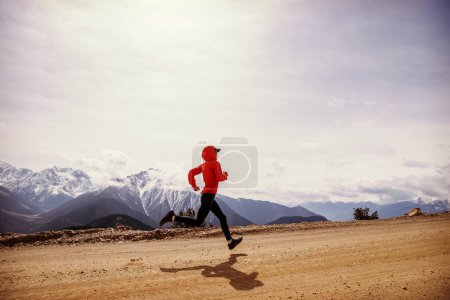 Photo for Woman trail runner cross country running at high altitude mountains - Royalty Free Image