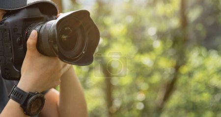 Photo for Photographer taking pictures in summer mountains - Royalty Free Image