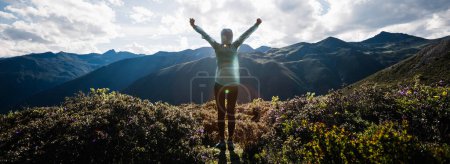 Photo for Successful woman outstretched limbs at high altitude mountain peak - Royalty Free Image