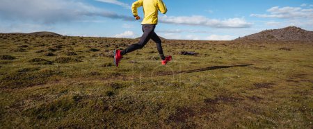 Photo for Woman trail runner cross country running to high altitude mountain peak - Royalty Free Image