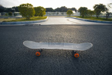Photo for Skateboard outdoors in sunrise city - Royalty Free Image