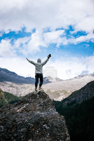 Photo for Woman photographer taking photo on mountain top - Royalty Free Image