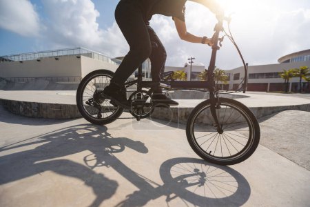 Photo for Riding folding bike in skate park - Royalty Free Image