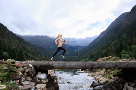 Photo for Woman trail runner cross country running in high altitude mountains - Royalty Free Image