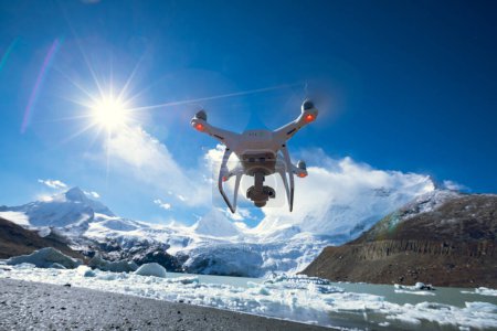 Photo for White flying drone taking picture of landscape in Tibet, China - Royalty Free Image