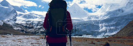 Photo for Woman backpacker hiking in winter mountains - Royalty Free Image