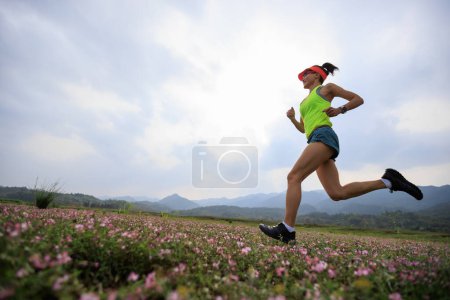 Photo for Woman runner running in spring - Royalty Free Image