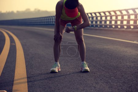Photo for Tired fitness woman runner running on seaside bridge - Royalty Free Image