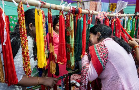 Photo for Nepali woman buys traditional beaded necklace at a stall, during North East Gurkha festival, on December 27, 2023 in Guwahati, Assam, India. Gorkha Development Council organised the North East Gurkha Festival to showcase the rich heritage of the Gork - Royalty Free Image
