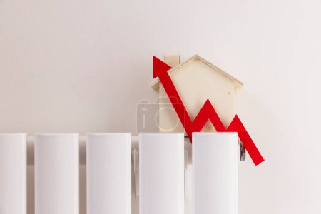 Cost of living crisis. red increasing arrow on a radiator. Rising cost of energy and bills.