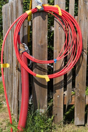 Photo for Red empty tube with photovoltaic cable and solar cable - PV system and energy - Royalty Free Image