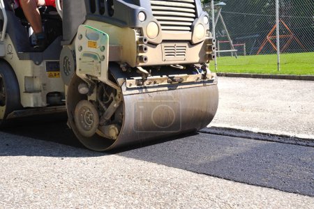 Foto de Trabajos de construcción - asfaltado y trabajadores con compactación de rodillos de carretera - Imagen libre de derechos