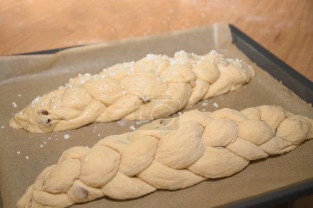 Photo for Brioche plait as dough rolls on the baking tray - yeast plait as dough - Royalty Free Image