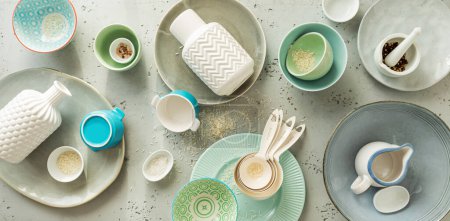 Photo for Collection of various ceramic, pastel coloured dishes (kitchenware). White, grey, green and blue composition from above (top view, flat lay). Kitchen poster or background. - Royalty Free Image