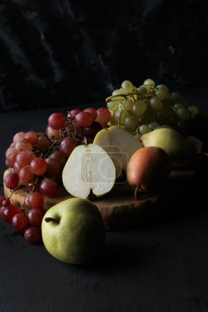Téléchargez les photos : Fruits, raisins, poires sur fond noir - en image libre de droit