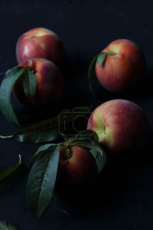 Photo for Peaches fruits on a black background - Royalty Free Image