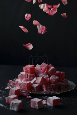 Photo for Rose flavored Turkish delight on a black background - Royalty Free Image