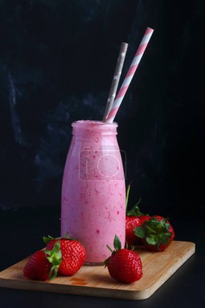 Photo for Strawberry smoothie on a black background - Royalty Free Image