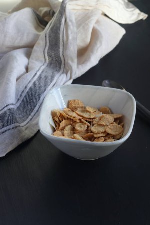 Photo for Bowl of cereal, cornflakes with milk in a bowl on a black background - Royalty Free Image