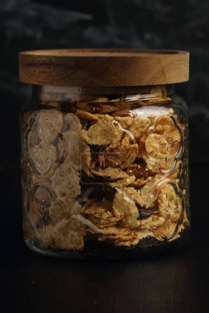Photo for Cornflakes in a glass jar on a black background - Royalty Free Image