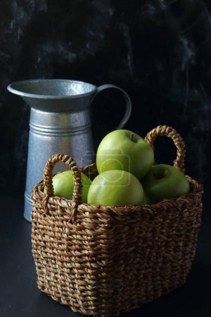 Photo for Green apples in a basket on a black background - Royalty Free Image
