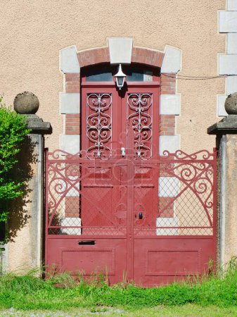 Photo for Cozy front door entrance in red colour of residential building in French village Vintage architecture. - Royalty Free Image