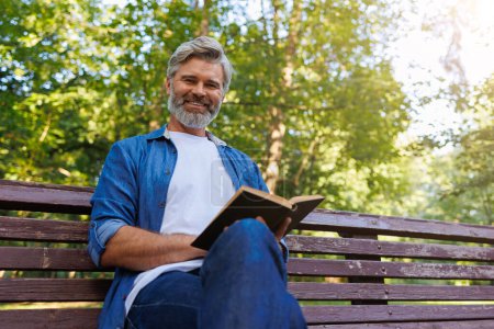Tranquil Park Scene: Man Engrossed in Reading