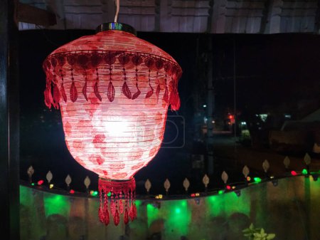 Téléchargez les photos : Photo d'image de belle lanterne de couleur rouge suspendue à la cour avant de la maison, lumière décorative colorée pendue au mur de fantaisie. Photo prise pendant la nuit de diwali à Gulbarga, Karnataka, Inde - en image libre de droit