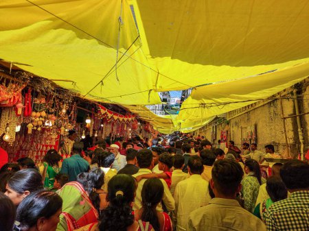Photo for Tuljapur,India- October 28th 2022; Outside view of Goddess Tulaja bhavani mata temple, crowd of devotees for visit in festival season.small shop around it, selling worshiping items, flower to devotees - Royalty Free Image