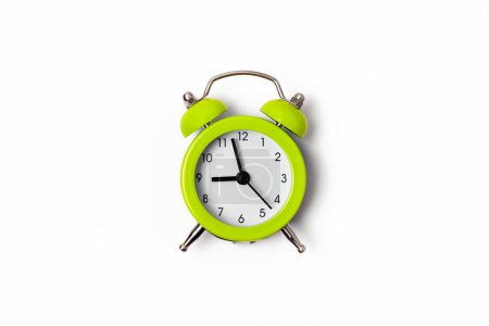 Photo for Beautiful lime green metal alarm clock isolated on white background. Concept of time. On the clock face, its five minutes to nine in the morning. - Royalty Free Image