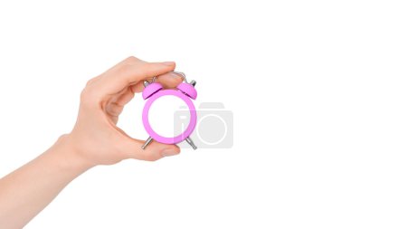 Photo for Hand holding beautiful small pink alarm clock isolated on white background. Concept of time. Clock face isolated white as a mock up. - Royalty Free Image