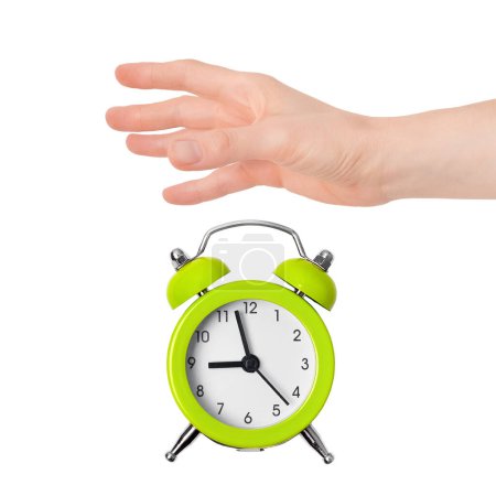 Photo for Hand dropping lime green metal alarm clock isolated on white background. Concept of time. On the clock face, its five minutes to nine in the morning - Royalty Free Image
