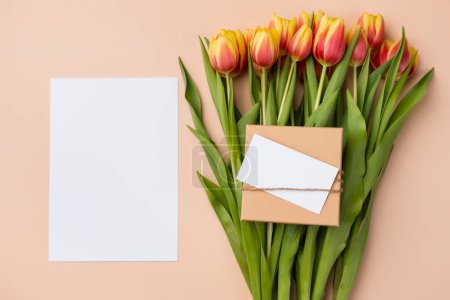 Photo for Vertical blank card mockup. Thank you card template with bouquet of tulips on a beige background. - Royalty Free Image