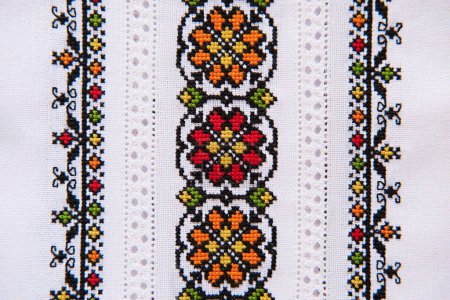 Photo for Slavic cross stitch by colored cotton threads. Design of ethnic pattern with cross stitch and hemstitch technique. Background with Embroidery Texture. - Royalty Free Image