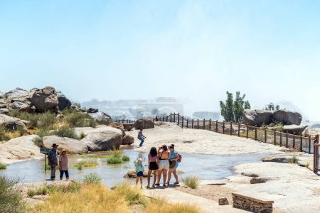 Photo for Augrabies National Park, South Africa - Feb 25, 2023: Tourists on a flooded footpath to the main viewpoint at the Augrabies waterfalls - Royalty Free Image